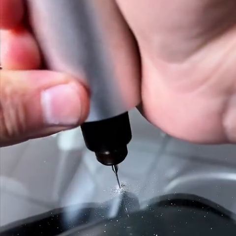 A fine drill over the impact point of a windscreen chip