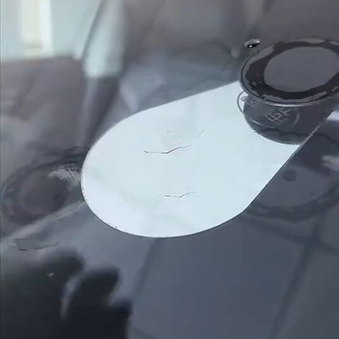 A curing film laid over a filled chip on a windscreen